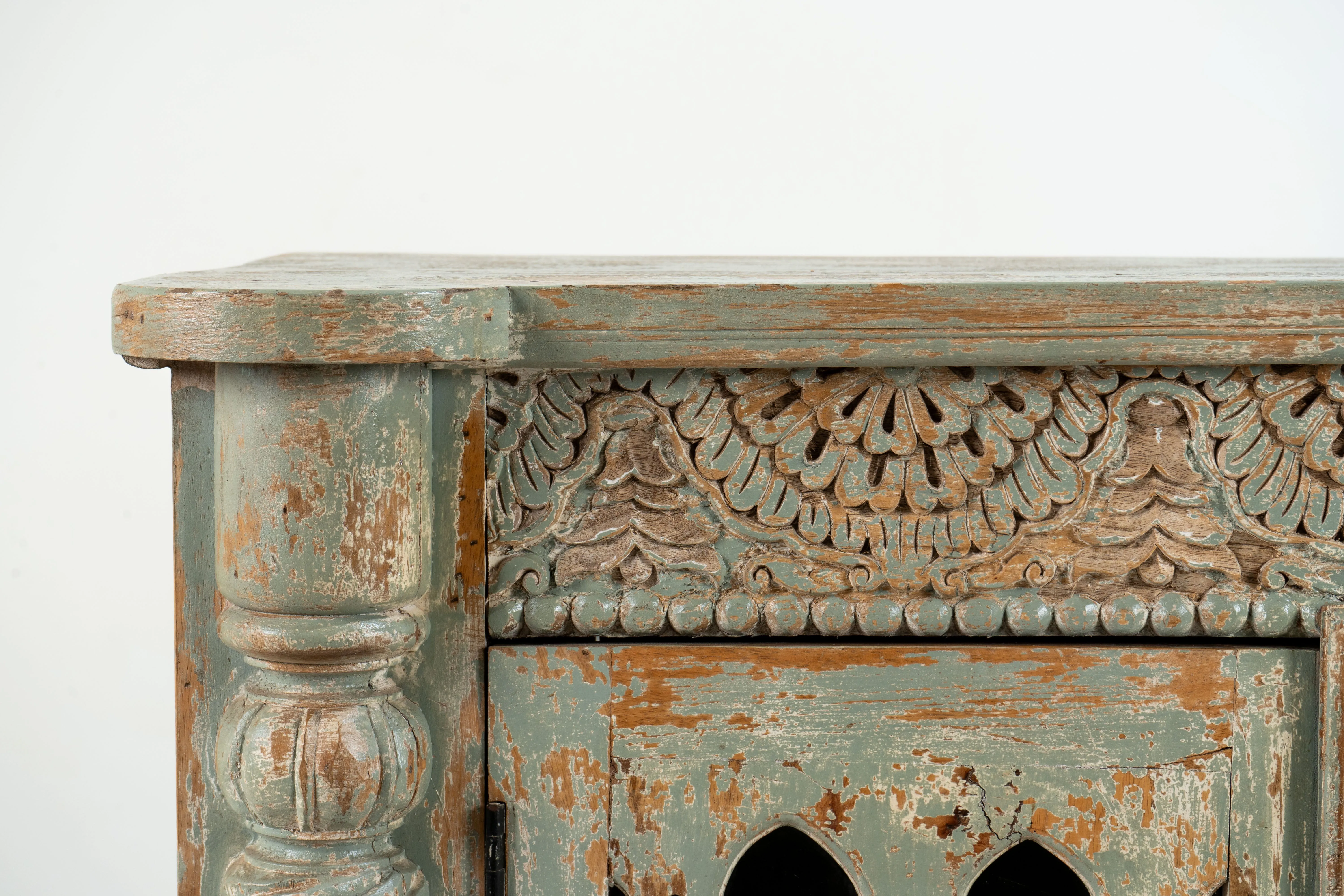 A Wooden Sideboard with Wooden Openwork Doors